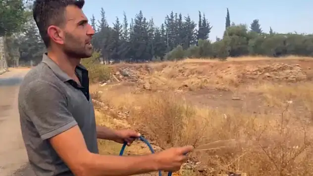 Antalya'da alevlerin yaklaştığı mahallede vatandaşlar hortumlarla nöbette